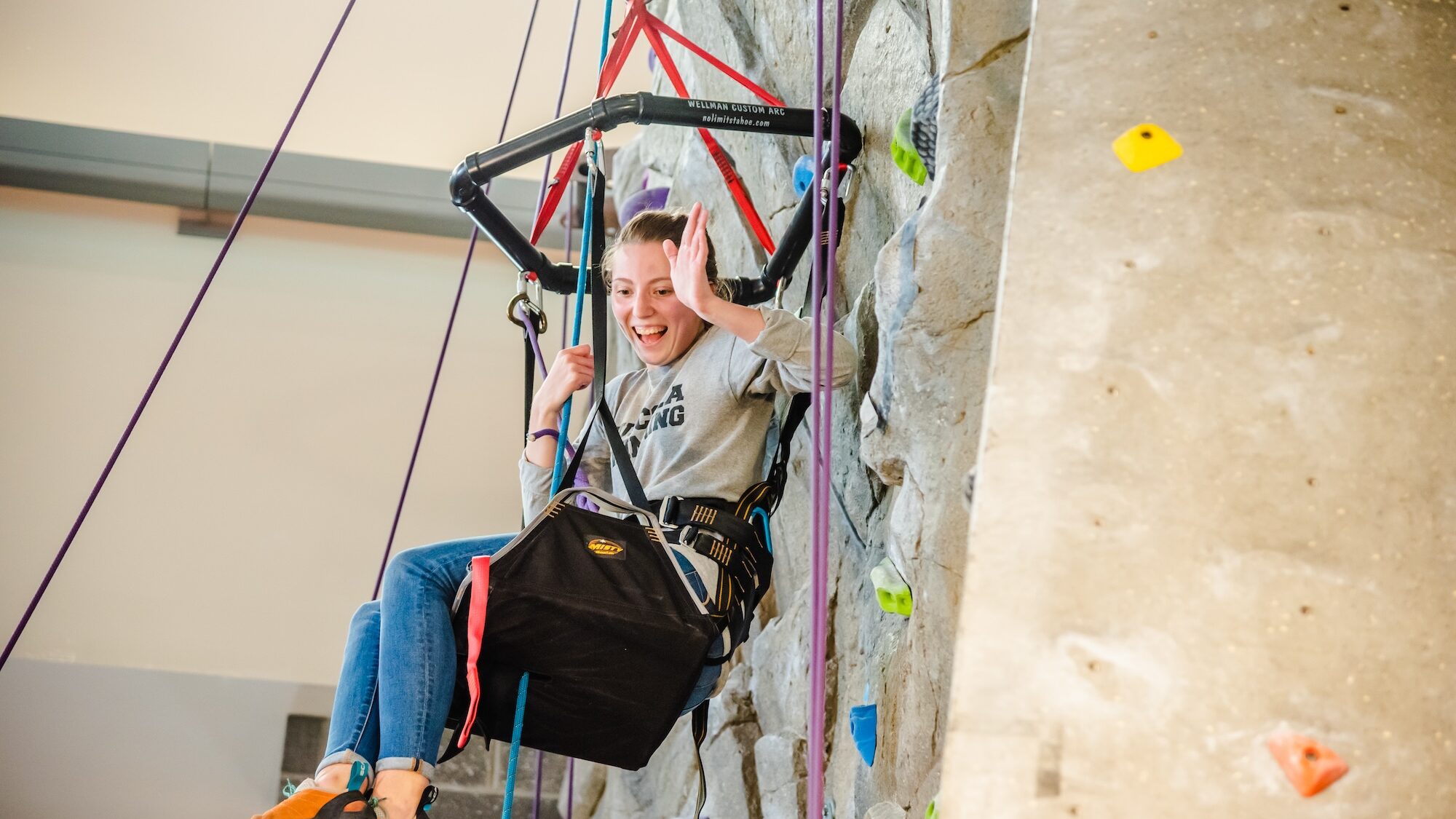 Student participating in adaptive climbing at the Kaplan Recreation Center