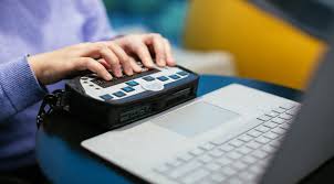 Individual using a braille embosser