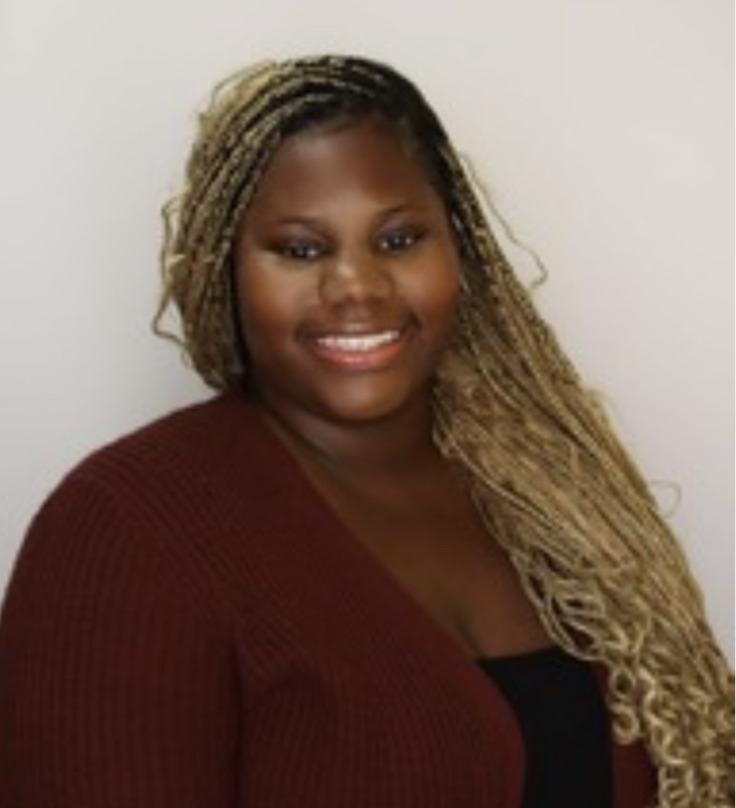 African American Female wearing burgundy top
